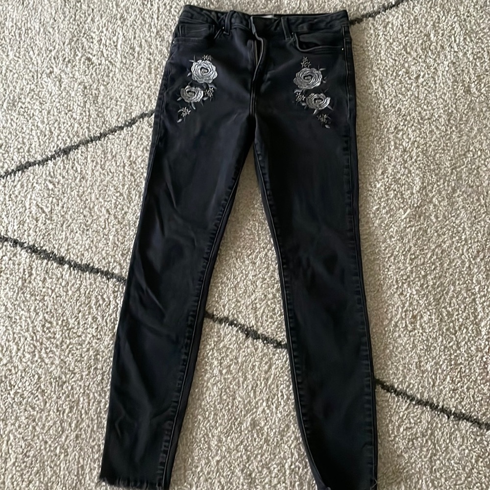 These jeans are the brand forever 21,the color black with flowers on them
